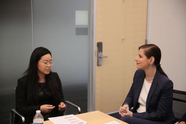 Xiaoxi Wang and Dean Katherine Baicker look at each other in conversation.