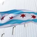 Image of the Chicago Flag on a flagpole in the wind. Ally Griffin/Unsplash