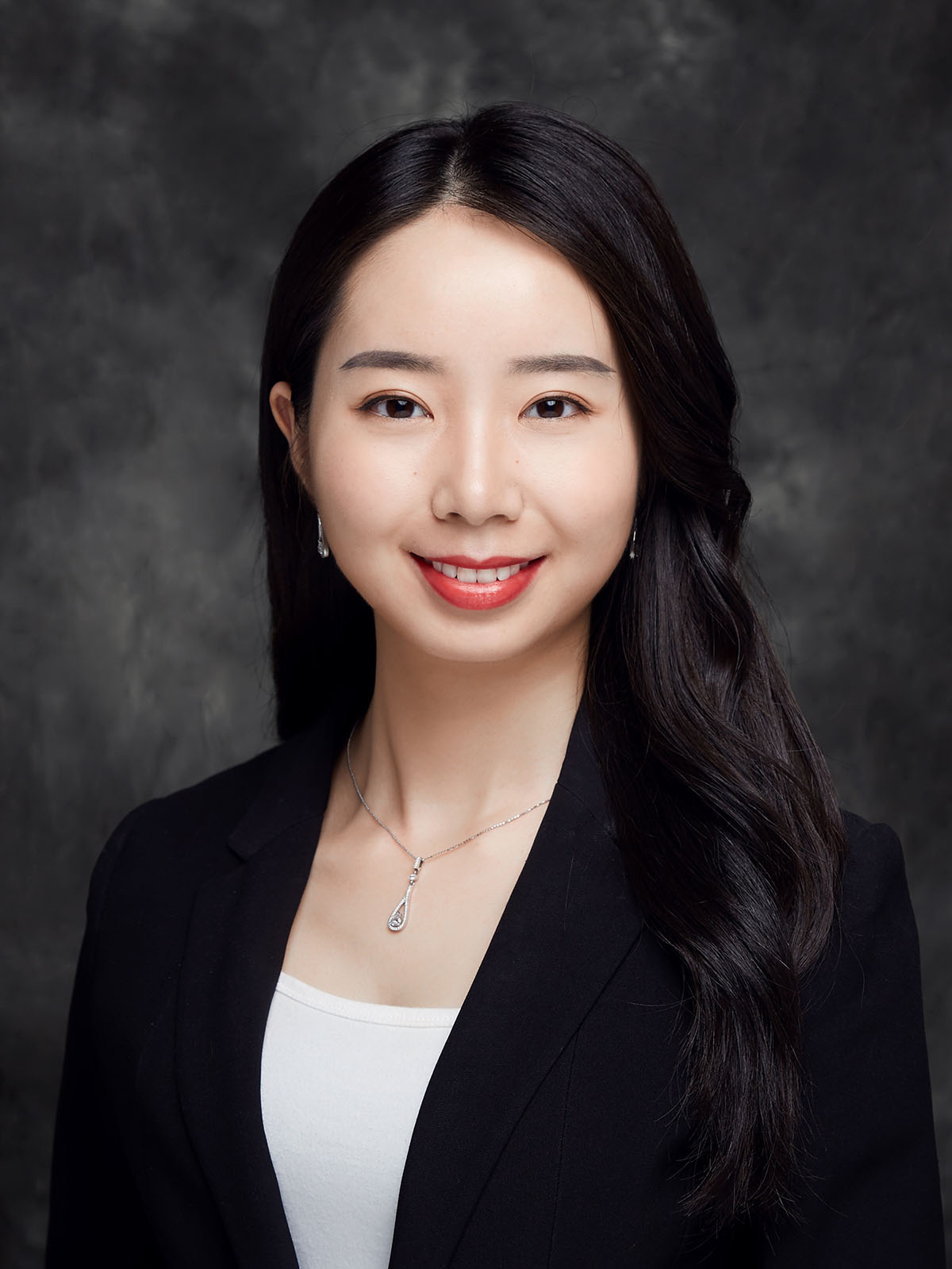 Jinghan Zhu smiling in a dark blazer and white shirt