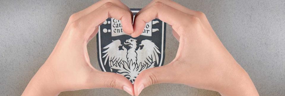 univeristy of chicago emblem with two hands forming a heart on top