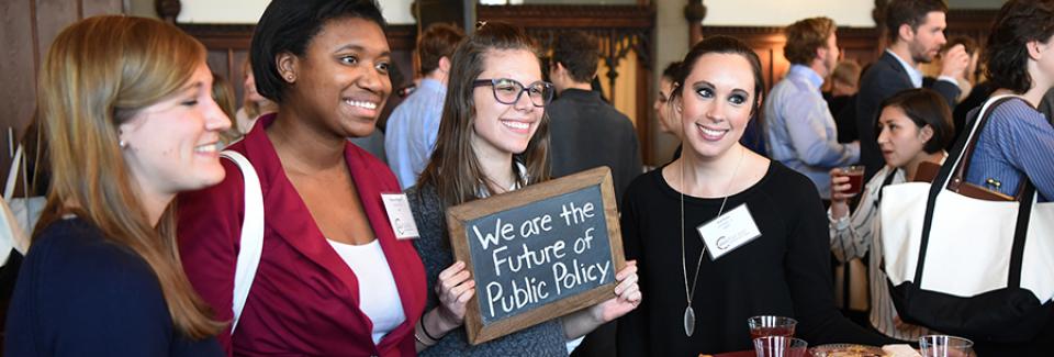admitted students smiling and holding a sign that reads: we are the future of public policy"