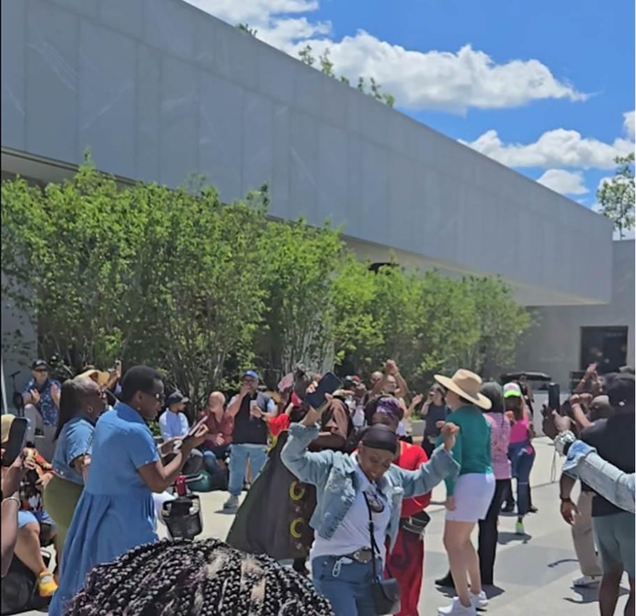 A crowd of participants in front of the Obama Center dancing on the opening on Juneteenth
