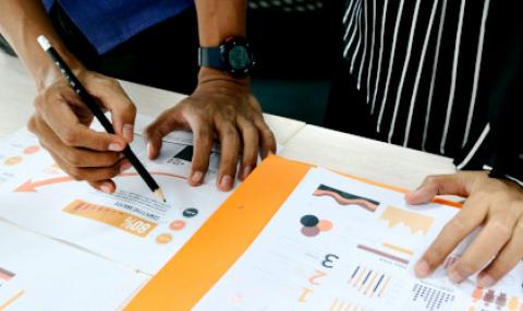 data charts with people working on them