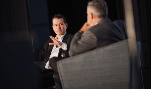 Jake Braun sitting and talking on stage.