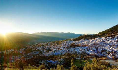 image of buildings with asian architecture amidst hilly region surrounded by forest