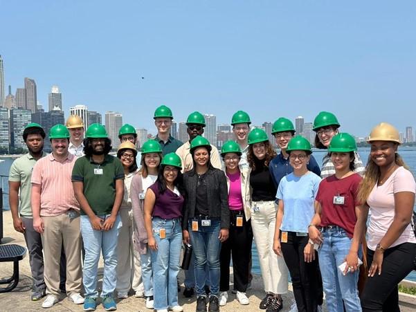 The Fellows wearing hard hats on a trip to the Water Purification Plant