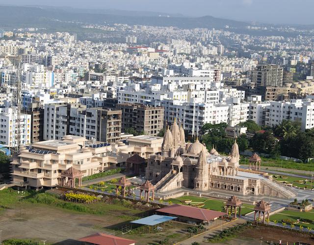 A photo of Pune, India, with a temple in the foreground