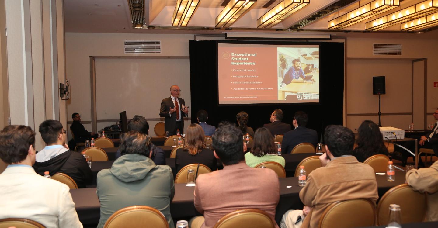 Dean Ethan Bueno de Mesquita speaking to event attendees
