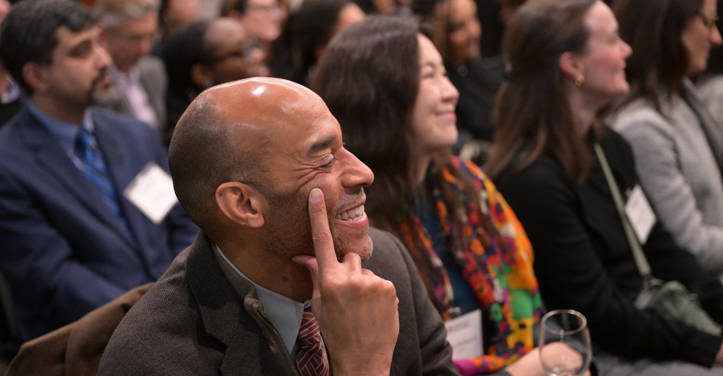 Event attendees with one attendee smiling