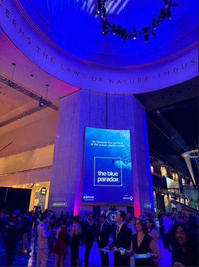 students at the spring soiree in the museum of science and industry mingling in glowing blue light