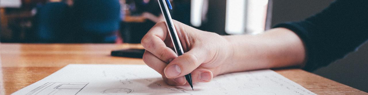 hand taking notes