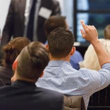 student with raised hand