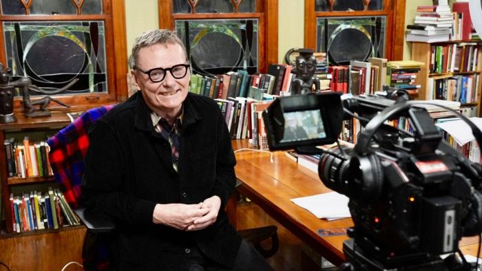 James Robinson at his home desk preparing for an interview