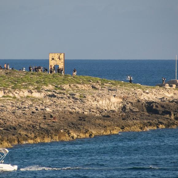 A land mass with people arriving