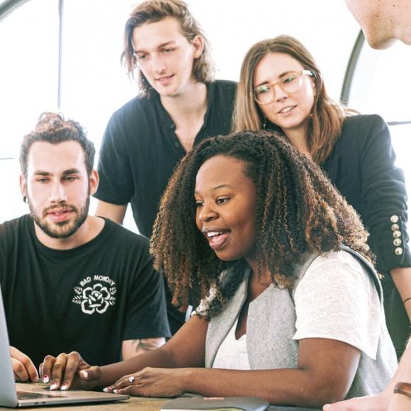 People looking on at a computer