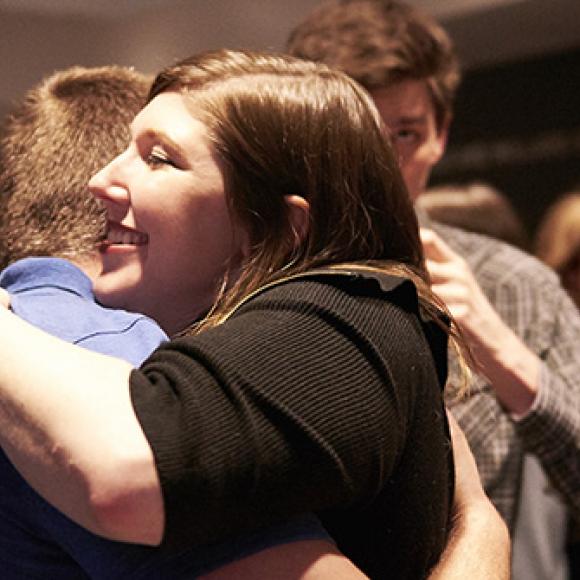students hugging