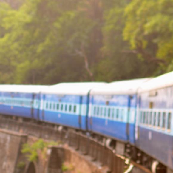 a person on a train through the mountains in india