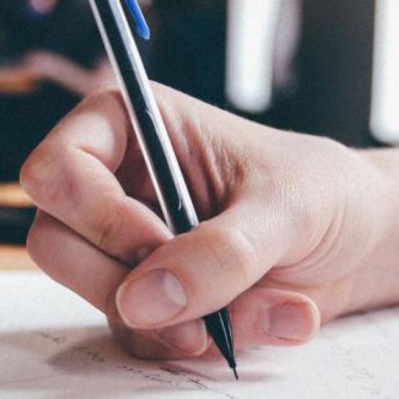 iname of hand holding pen
