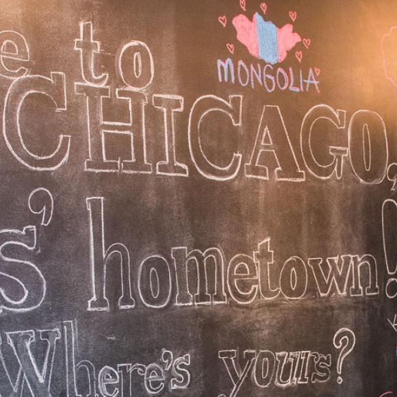 chalkboard with students hometowns written on it