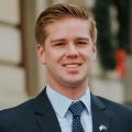 Andrew Beeler smiling in a blue suit jacket and blue tie