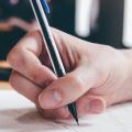 hand taking notes