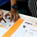 Hands annotating data analysis on paper